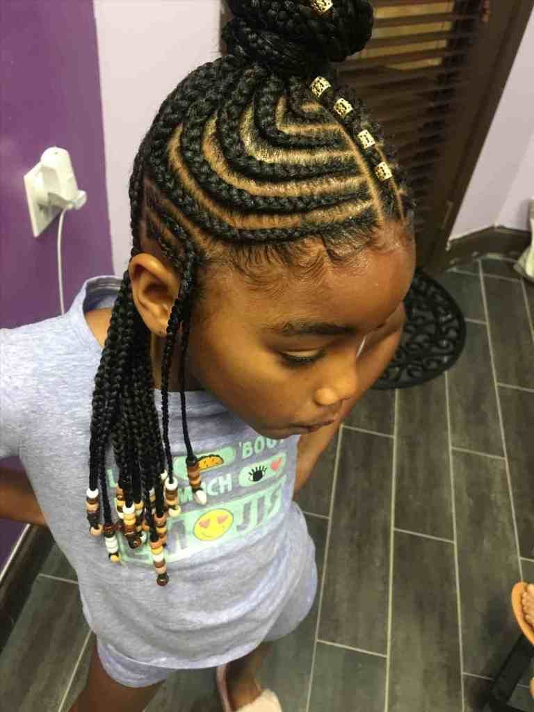 Circular Cornrows with a High Bun and Flowing Braids