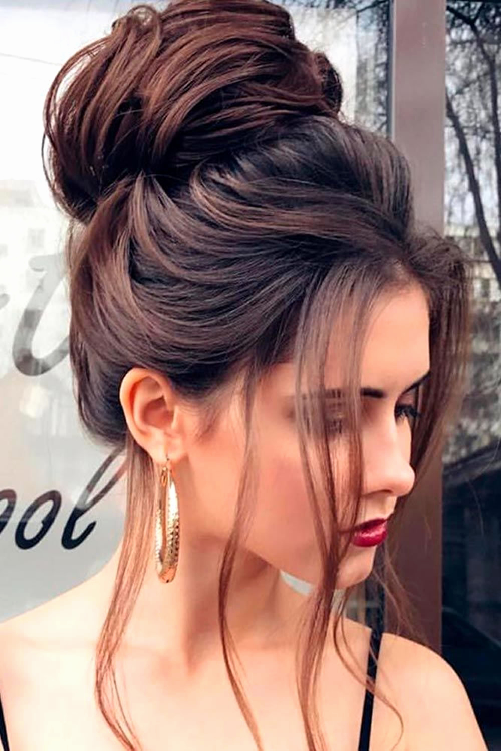 A Puffy Floral High Bun with Long Straight Fringes