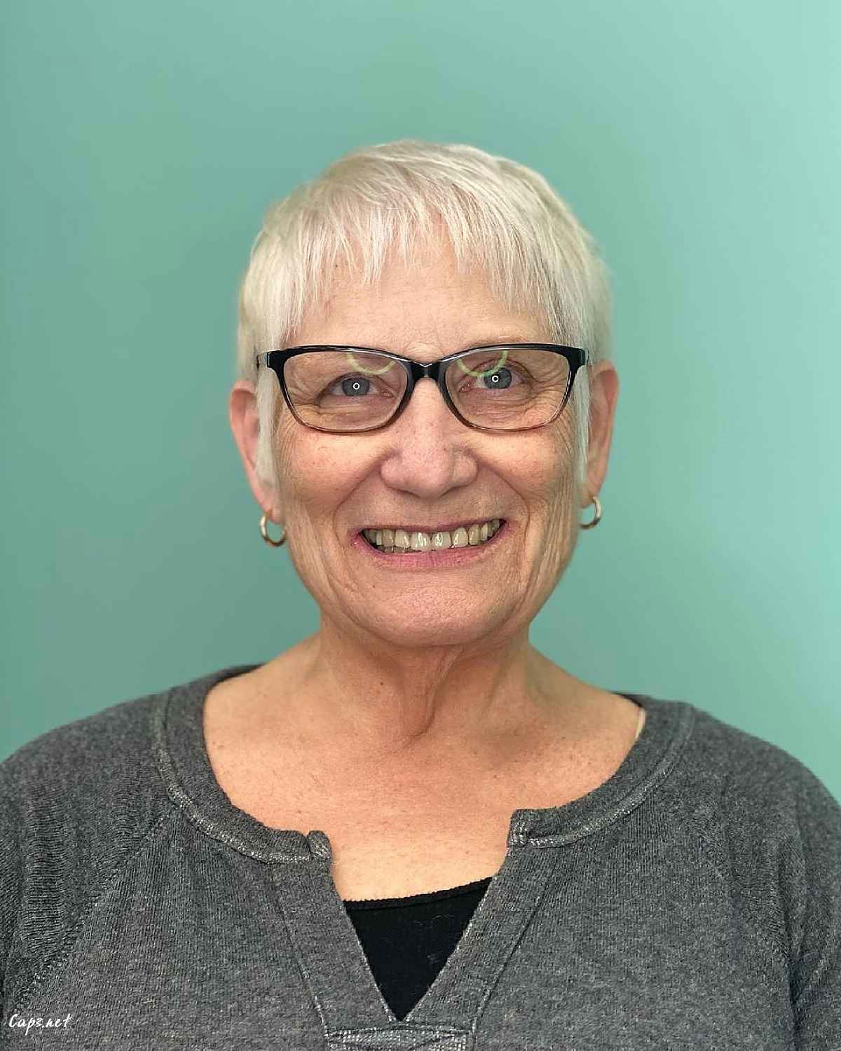 icy blonde short haircut with wispy micro bangs for women over 60s