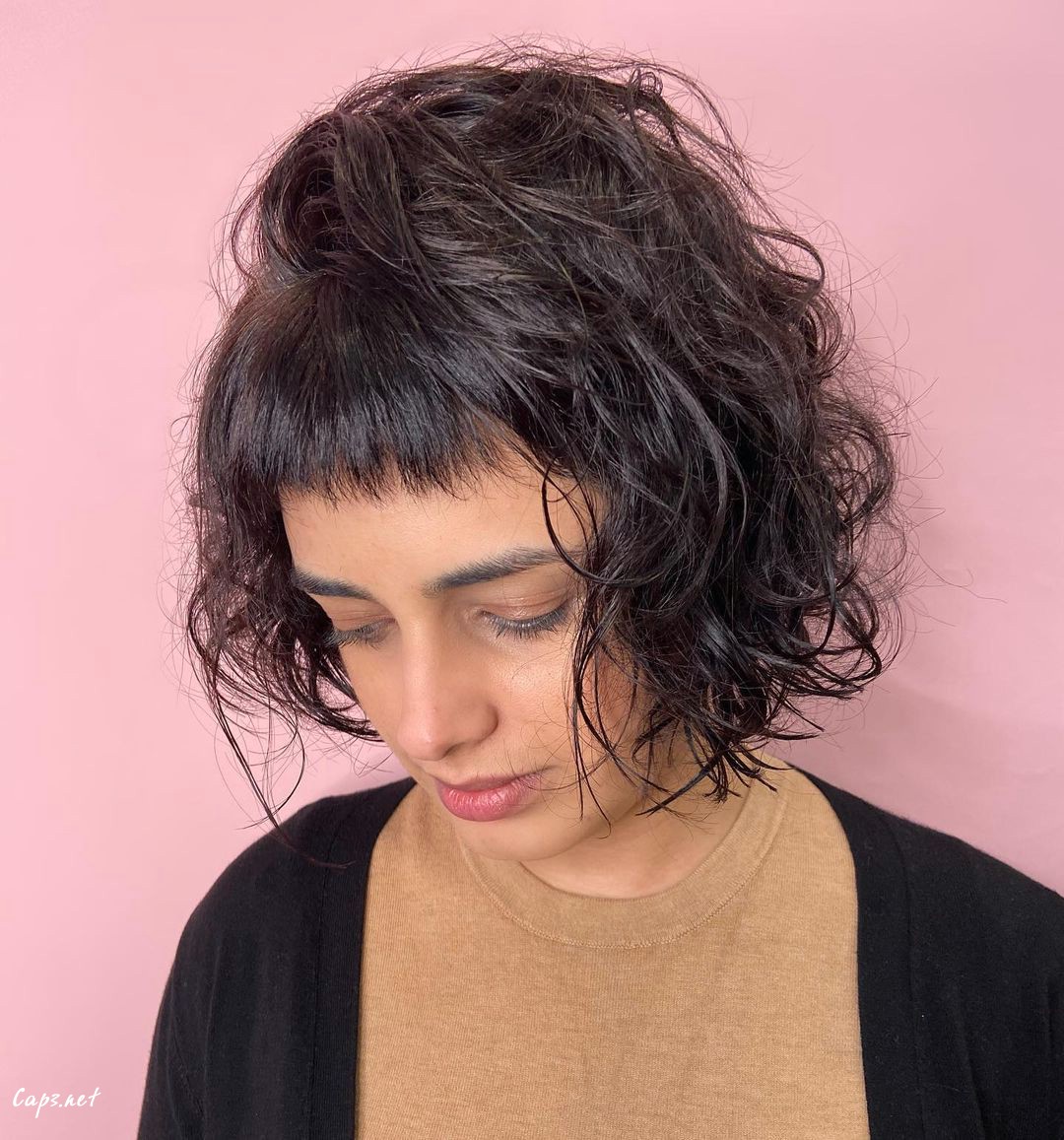 textured cut with choppy bangs and wavy hair