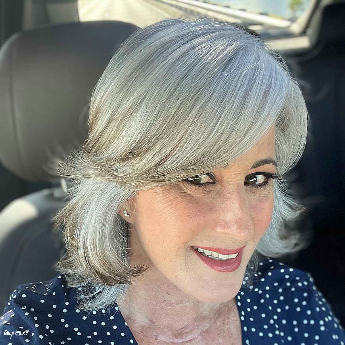 razor cut lob with long side swept bangs for women turning sixty