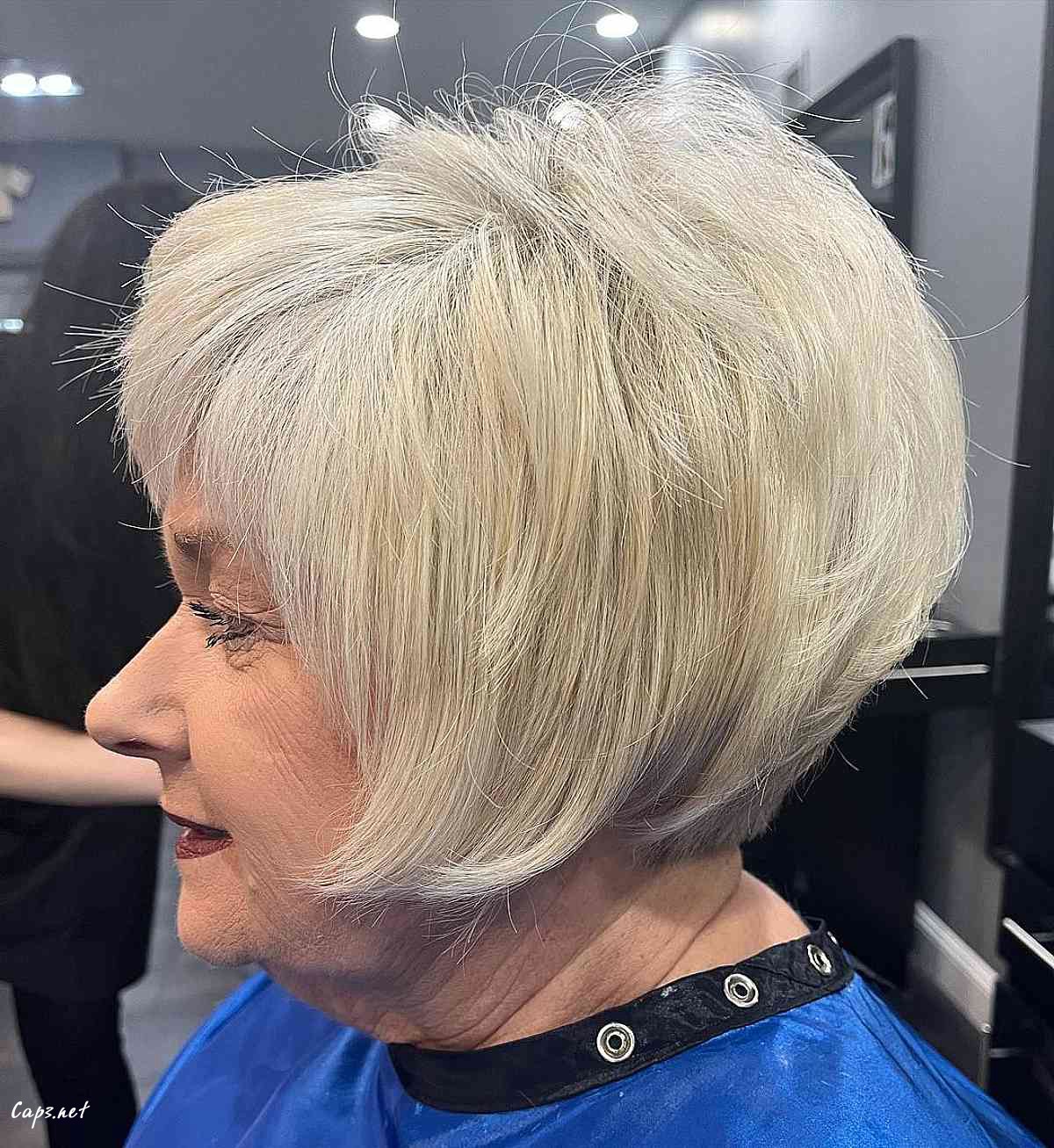 sleek angled bob with bangs for ladies over sixty