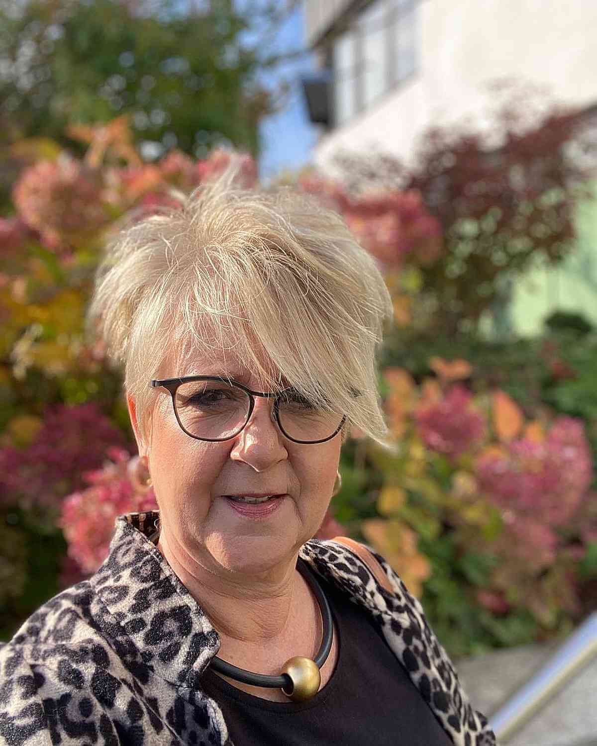 blonde pixie with extra long bangs for 60 year olds with glasses