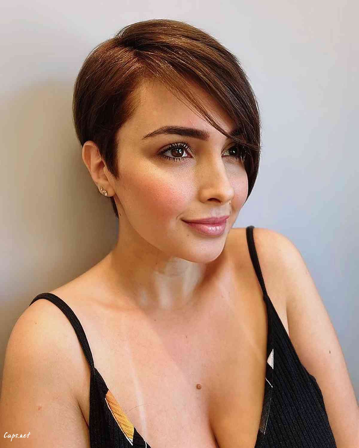 brunette side swept long pixie cut