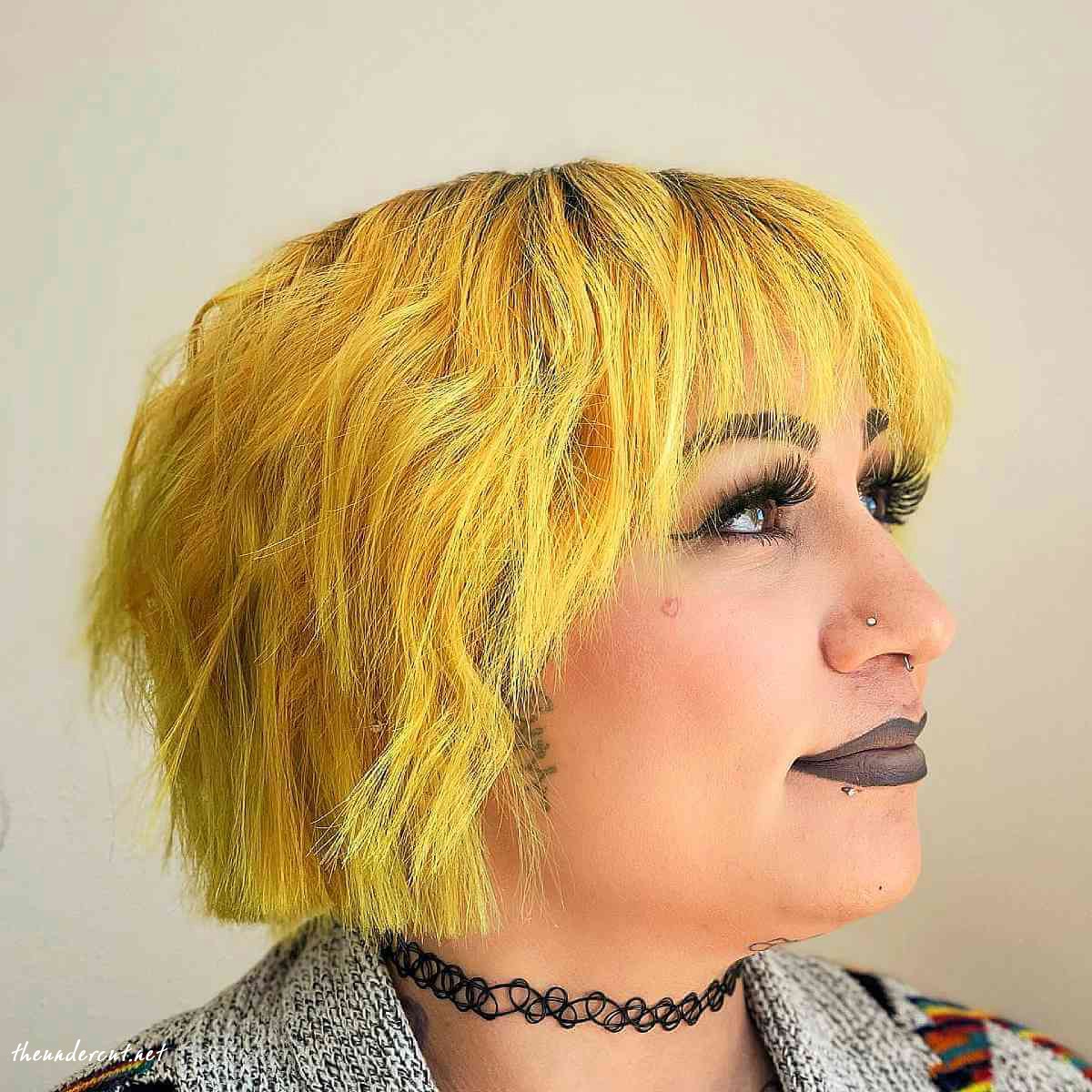 vivid yellow shaggy bob with long bangs