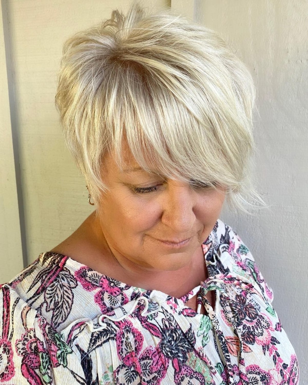 asymmetrically long pixie with side bangs for women over sixty