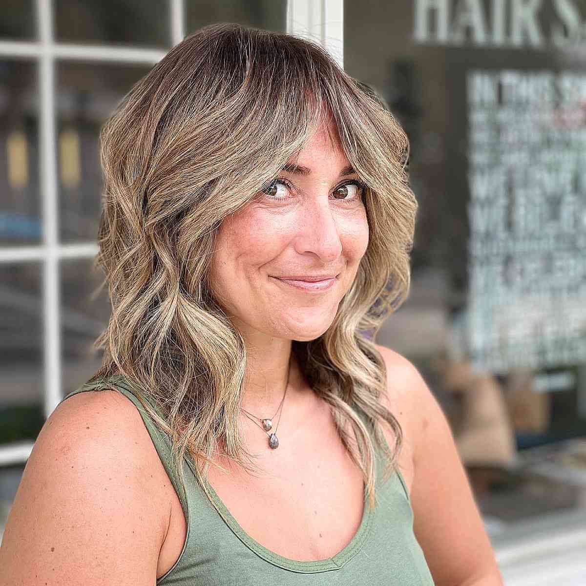 blonde long bob with curtain bangs for women over 40