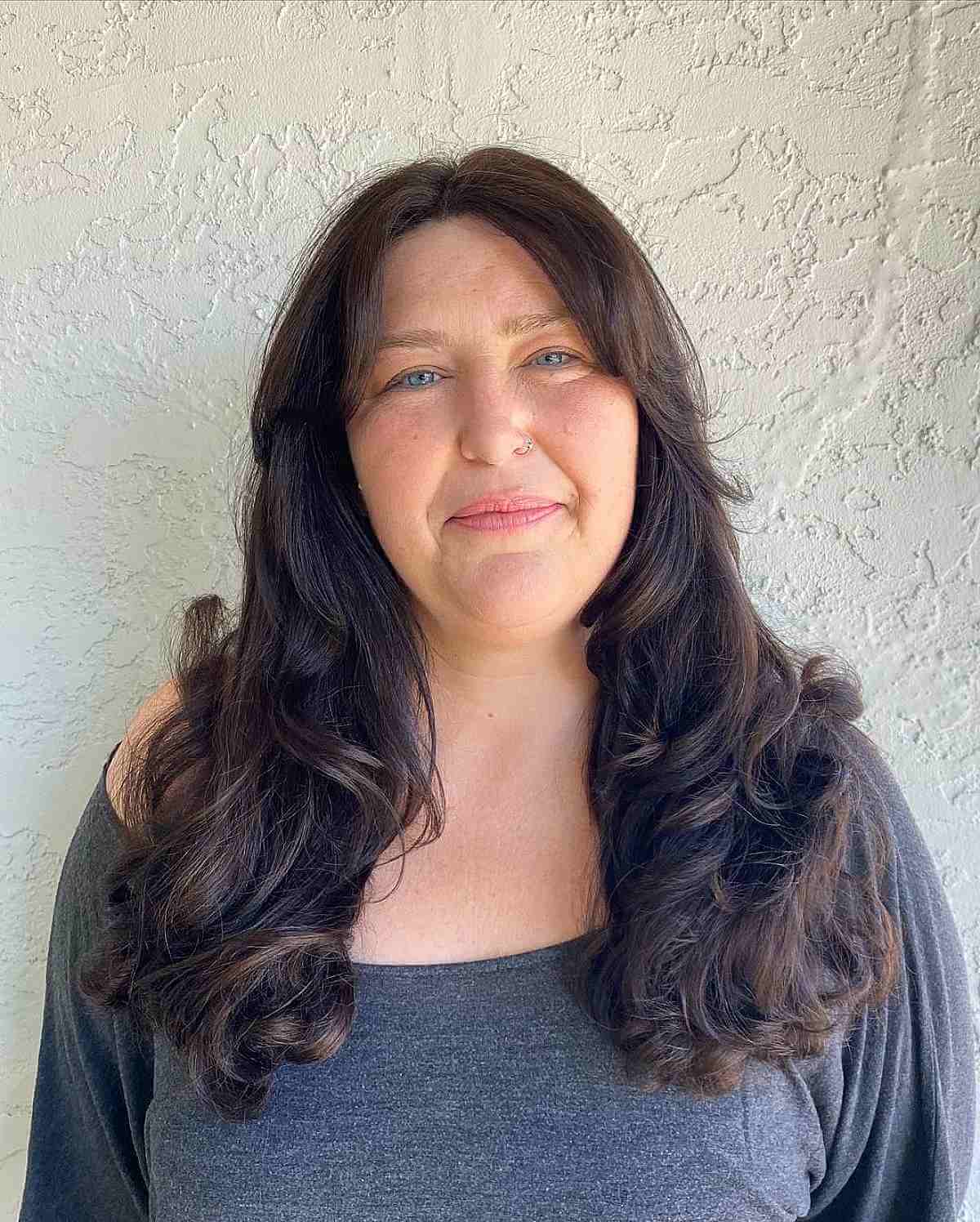 blowout style with face framing layers for a woman in her 40s