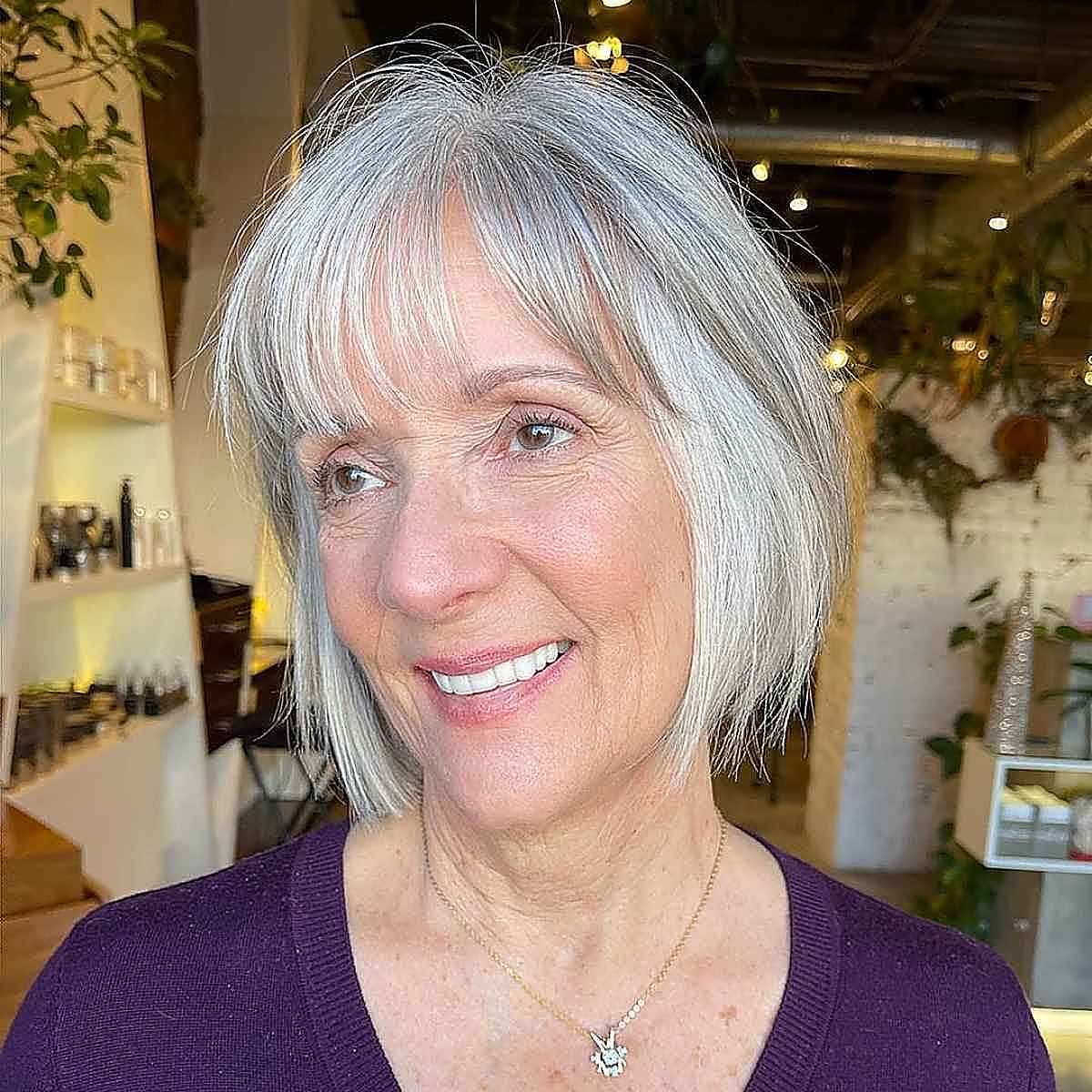 bob with face framing layers with wispy bangs for women over 60