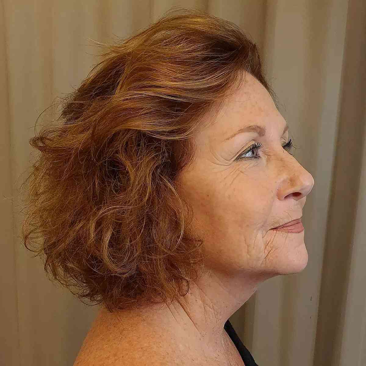 copper short bob with soft waves for a lady over 60 1