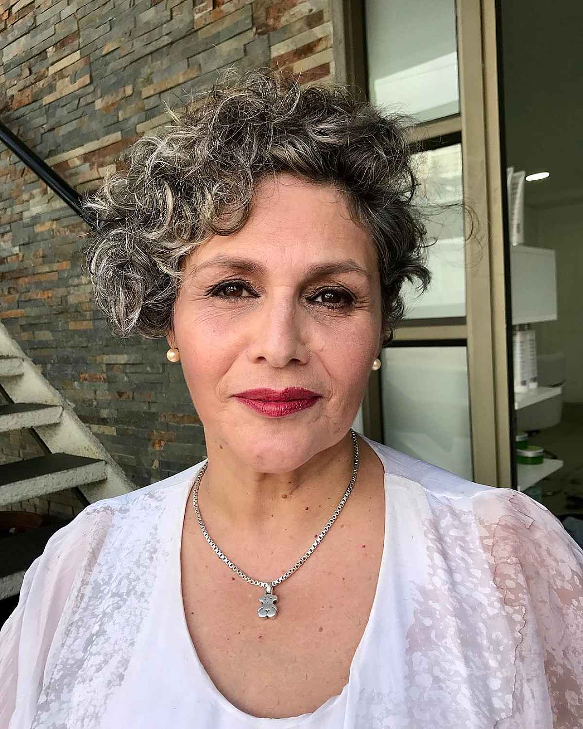 curly asymmetrical bob for a sixty year old woman with short hair