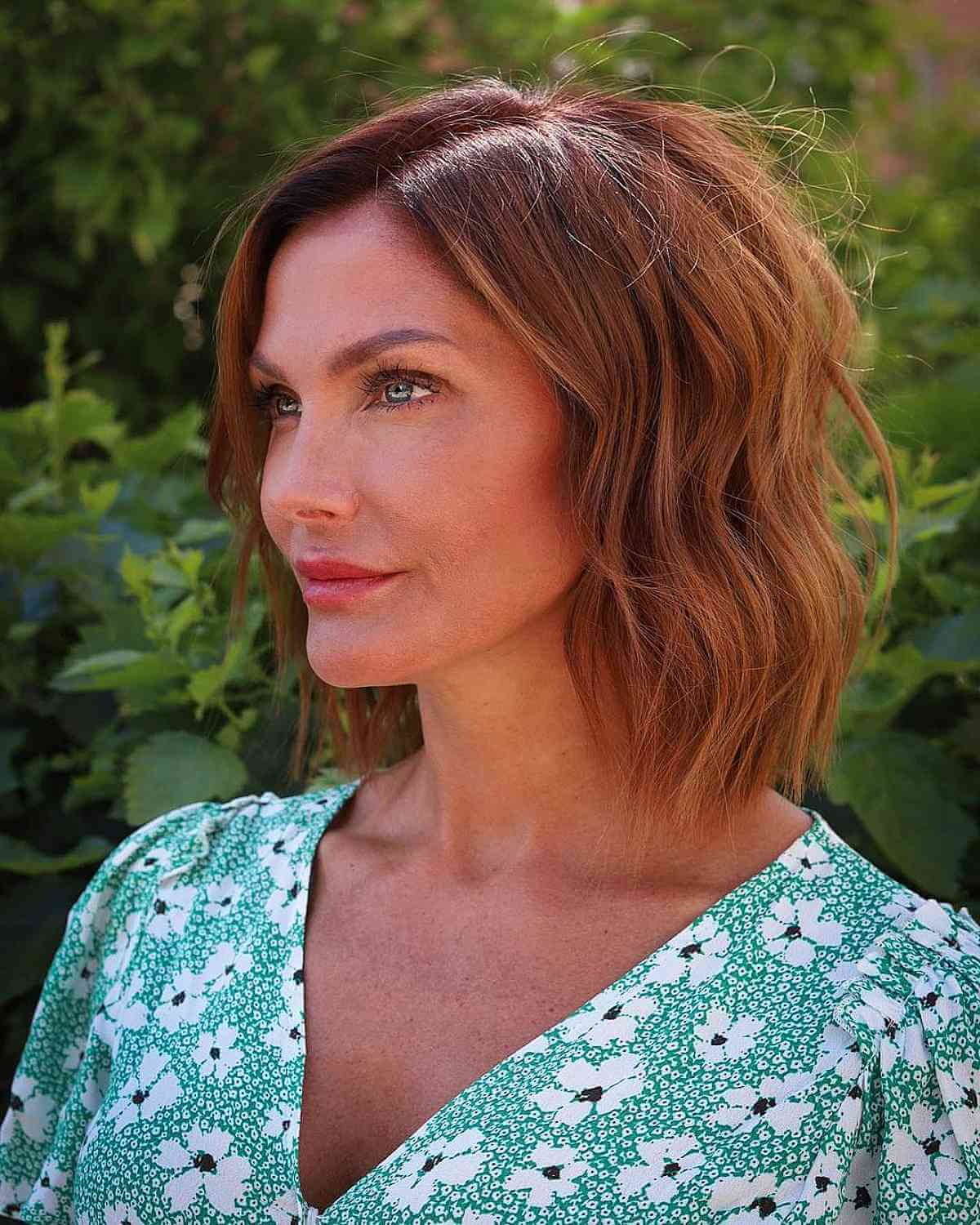 golden copper choppy lob with a side part