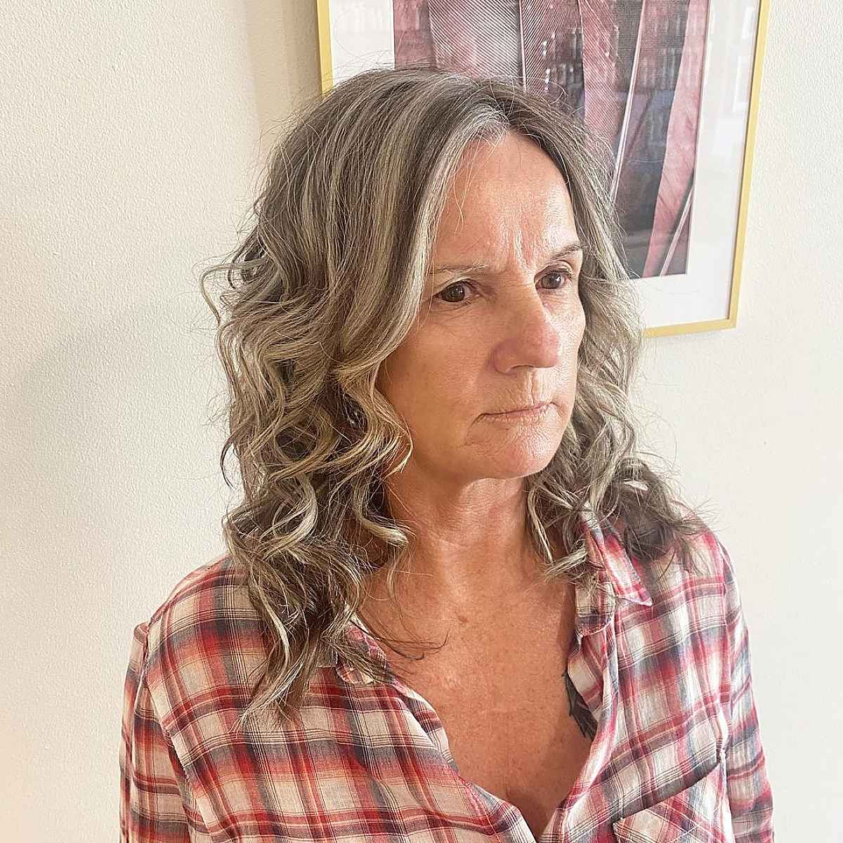 grey medium length cut with long layers for women over sixty with thin hair