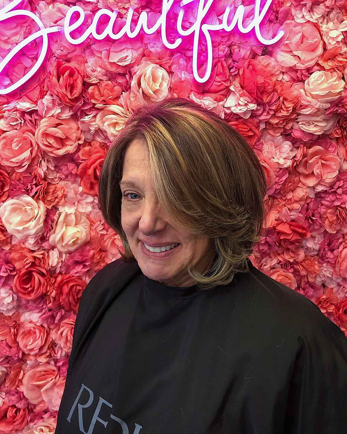 long graduated bob with feathered layers for a woman over sixty