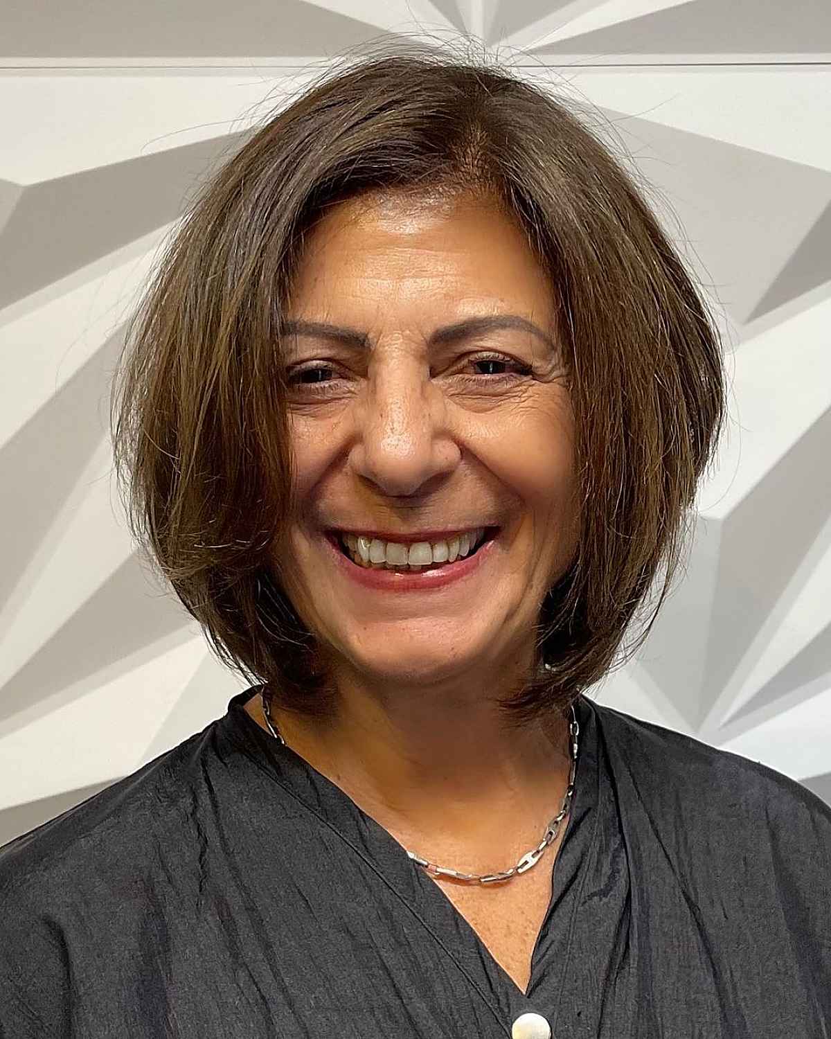 neck length cut with a side part for a woman over the age of sixty