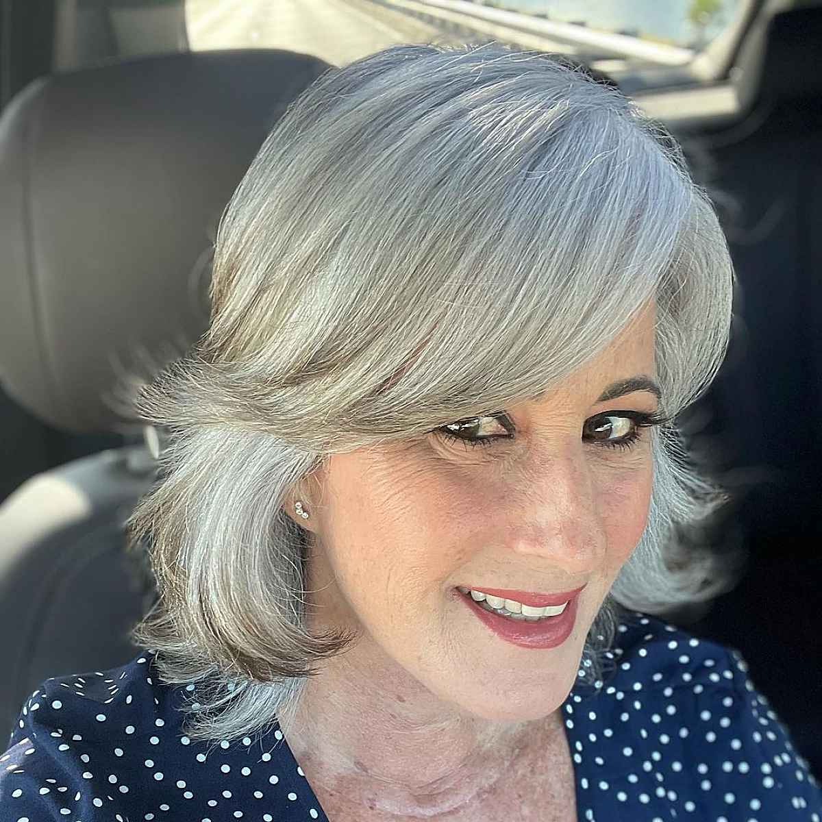 razor cut lob with long side swept bangs for women turning sixty