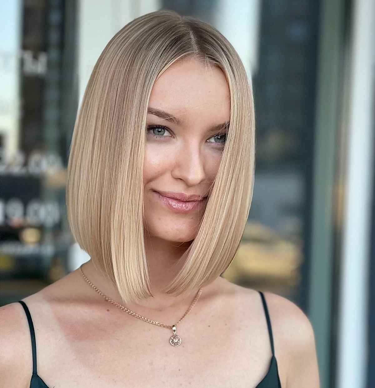 sharp long angled bob haircut with middle part