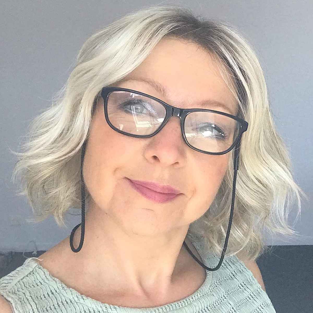 short bob for older women over 60 with glasses and a round face