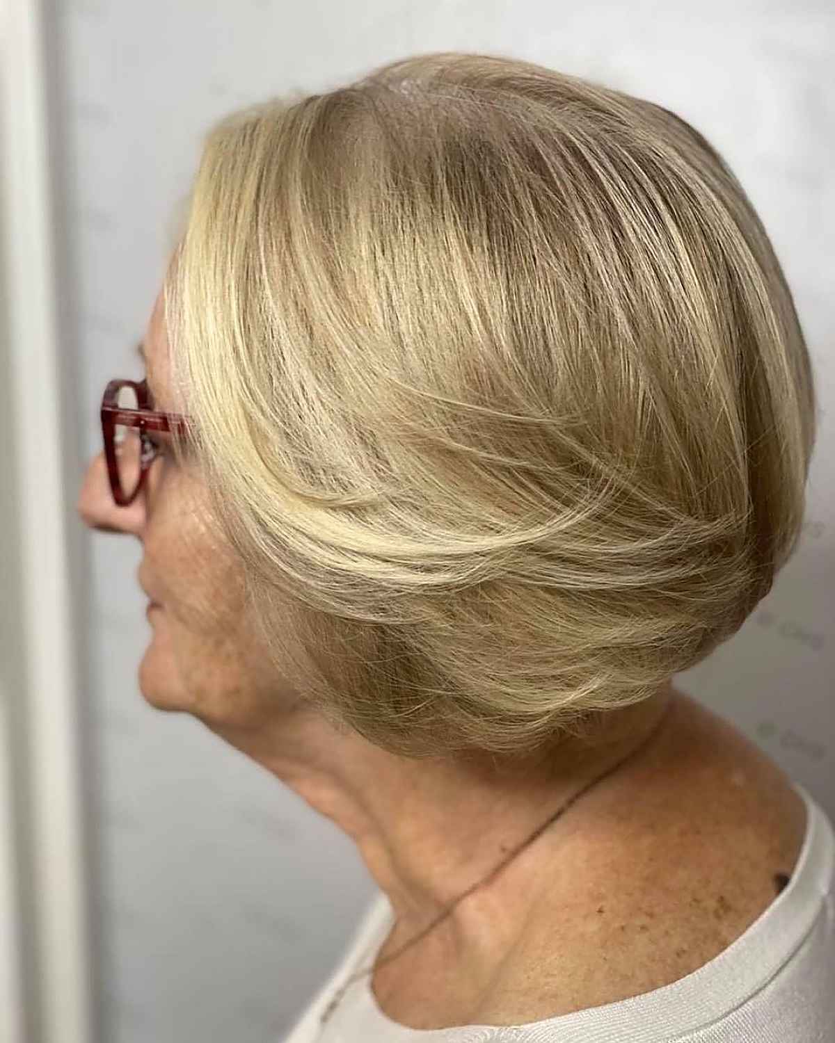 short feathered bob on a women in her sixties