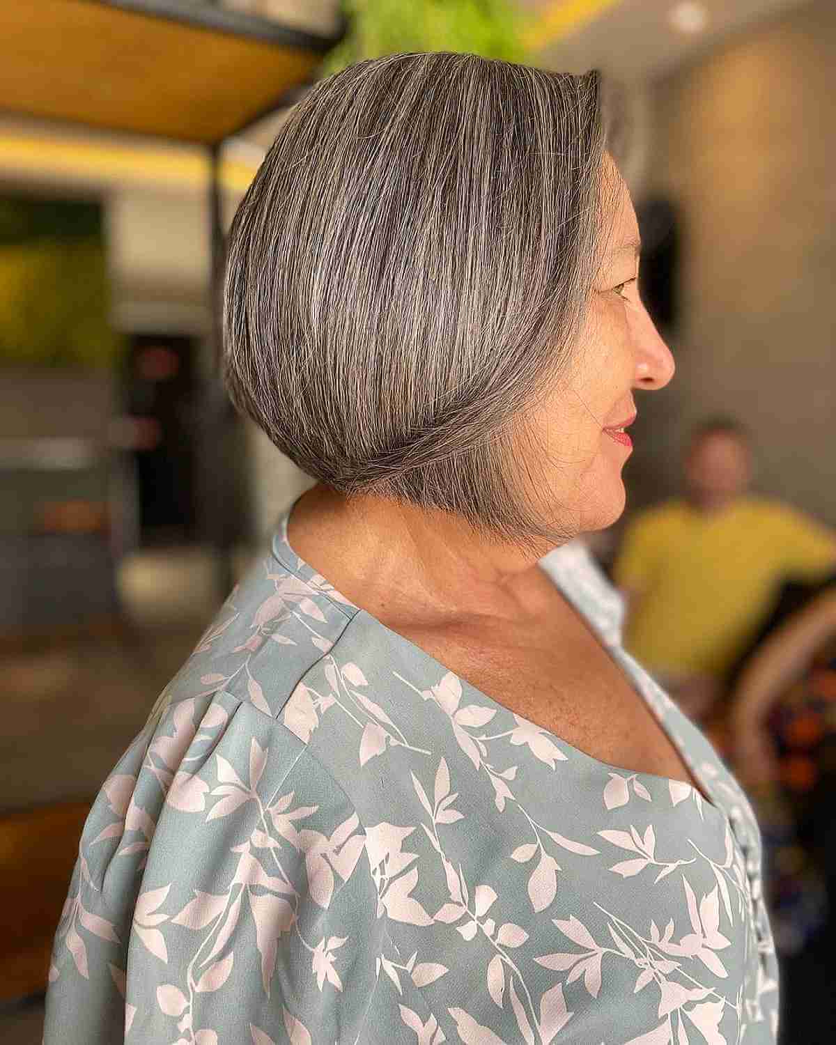 silver bob with long side bangs for women 60 and up 1