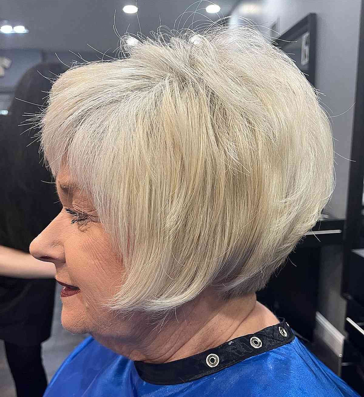 sleek angled bob with bangs for ladies over sixty