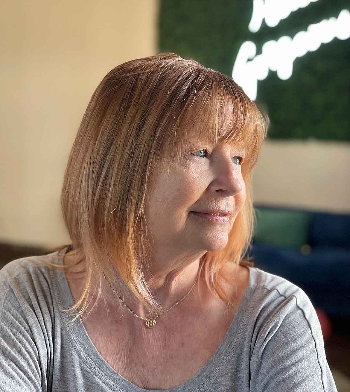 soft straight shaggy bob with wispy bangs for a 60 year old woman