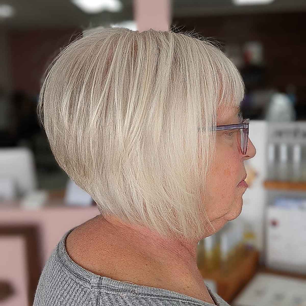 stacked and inverted bob with bangs for women in their 60s with fine hair