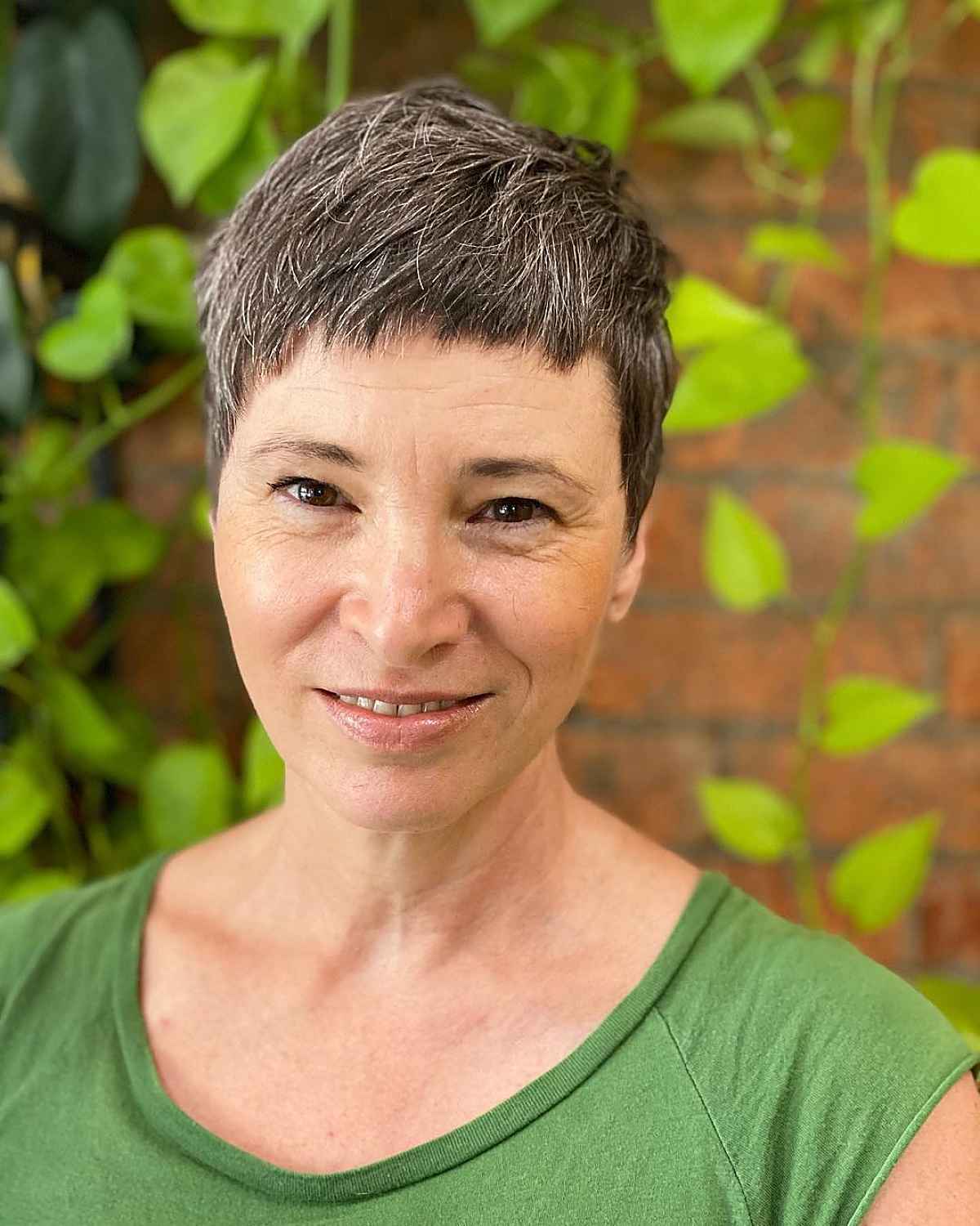 super short and textured asymmetrical cut with choppy bangs for women over 60