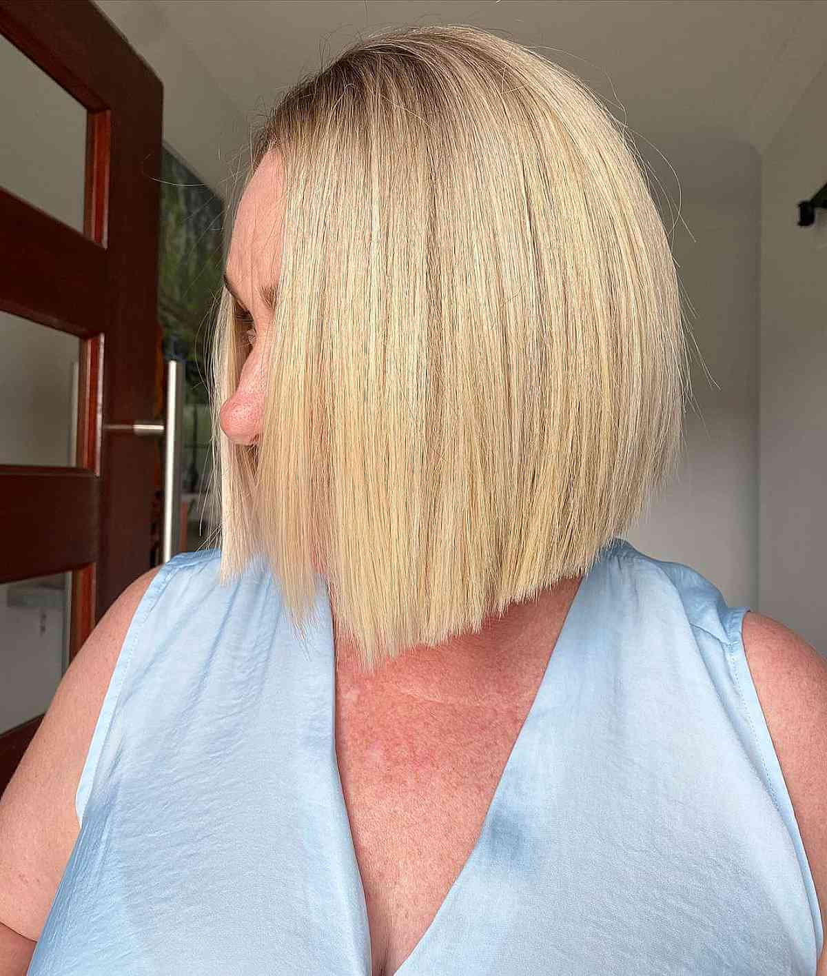 trendy blunt cut blonde bob style for ladies in their 60s