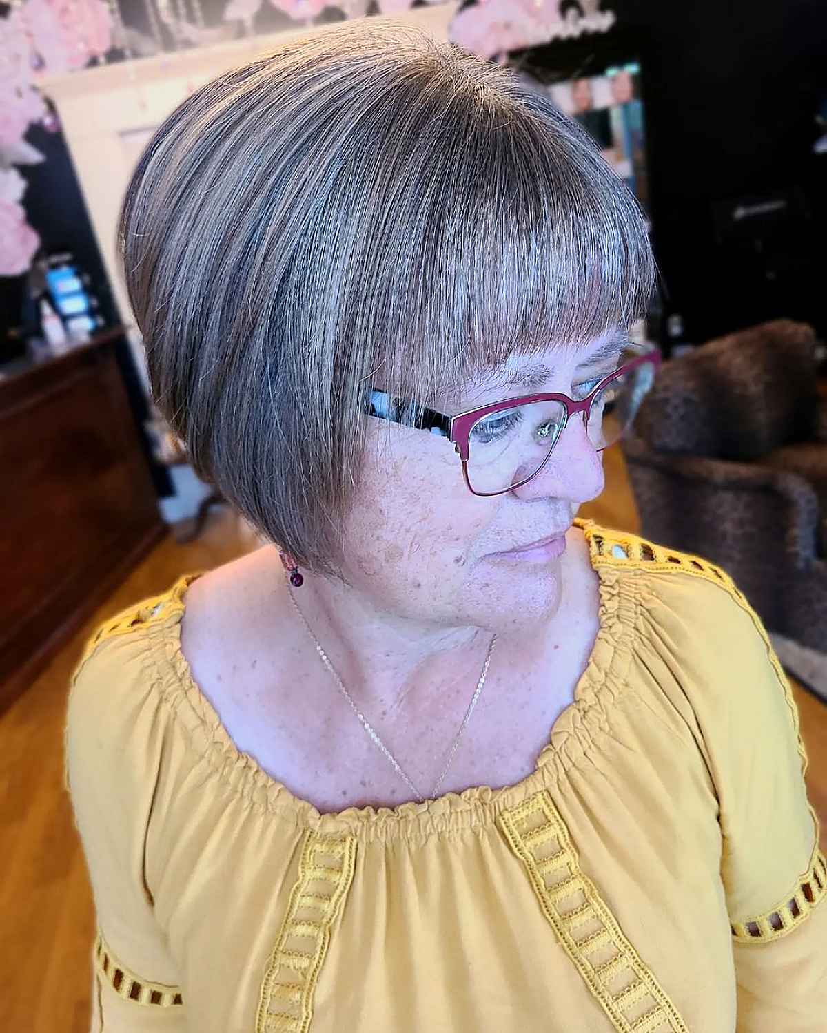 angled bob with feathered bangs for ladies over 60