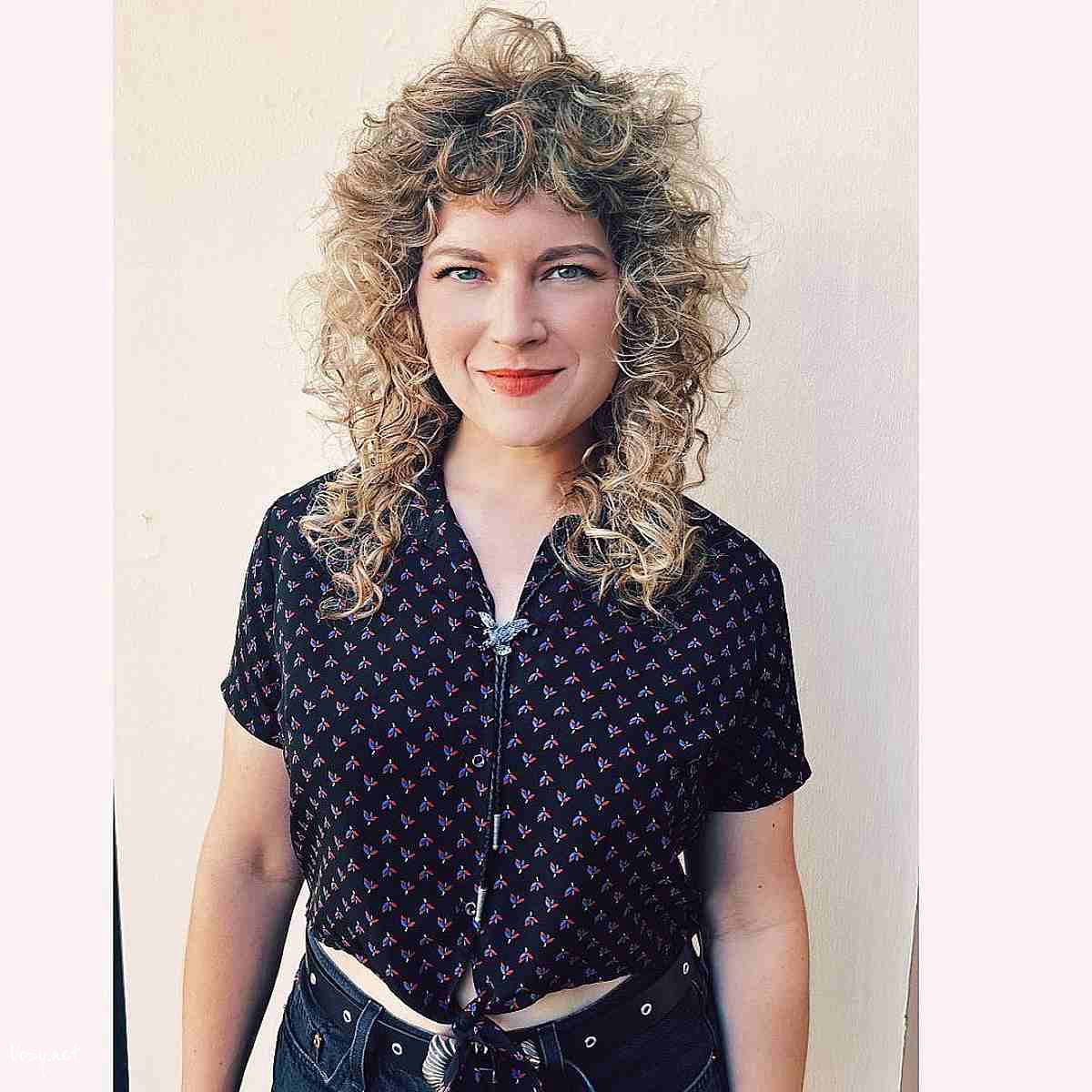 blonde curly shag with curly bangs hairstyle
