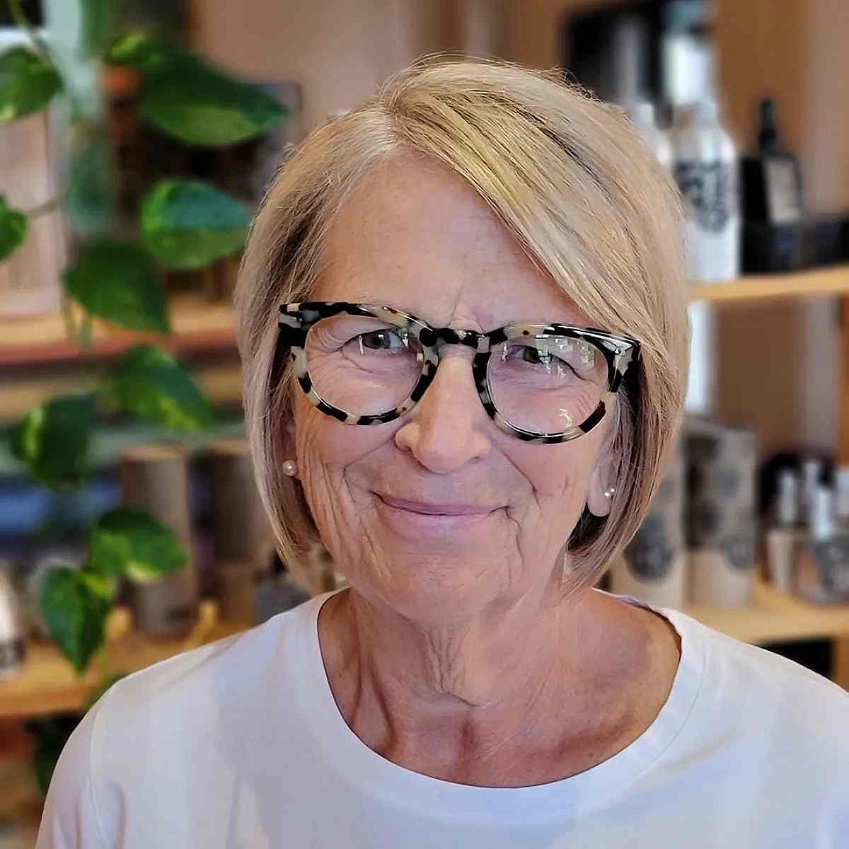 blonde short cut with a deep side part for 70 year olds with glasses