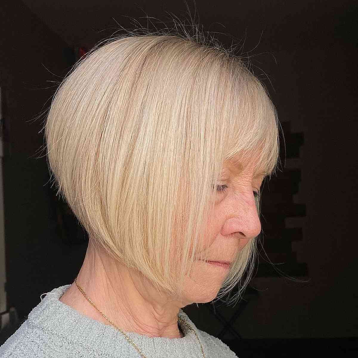 blonde stacked bob with bangs for ladies in their 70s