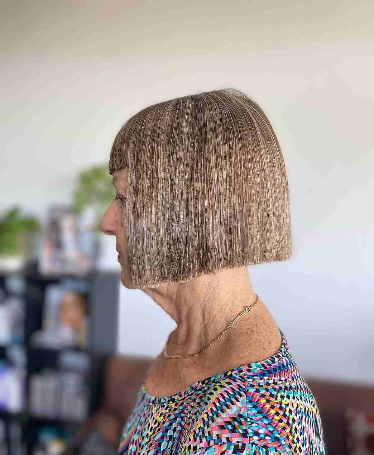 blunt short haircut with bangs for a 70 year old lady