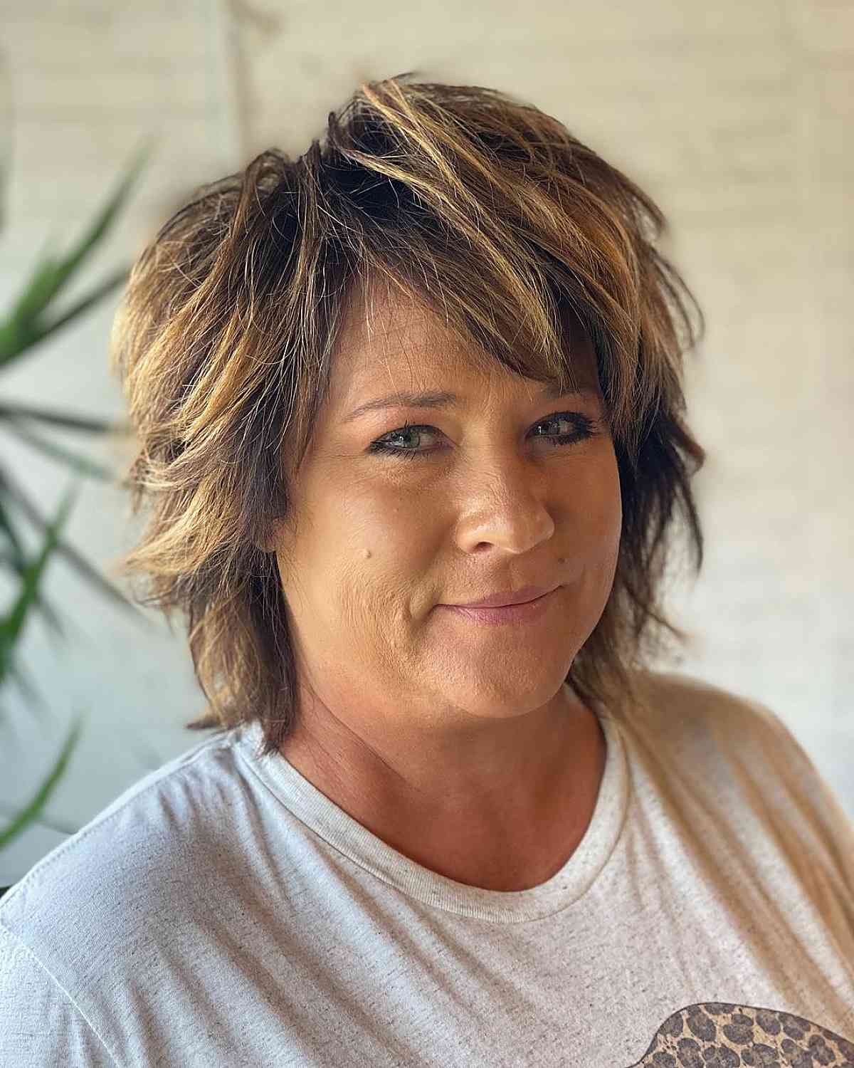 chic highlights on short hair with longer bangs for women over fifty