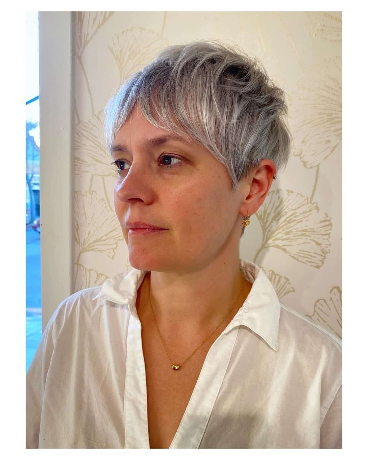 choppy gray pixie cut with long bangs for thick hair