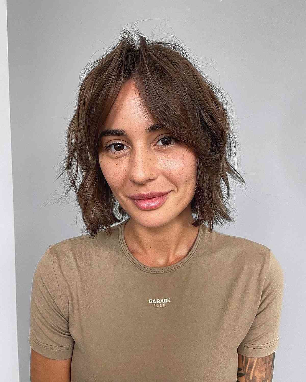 choppy neck length bob with curtain bangs