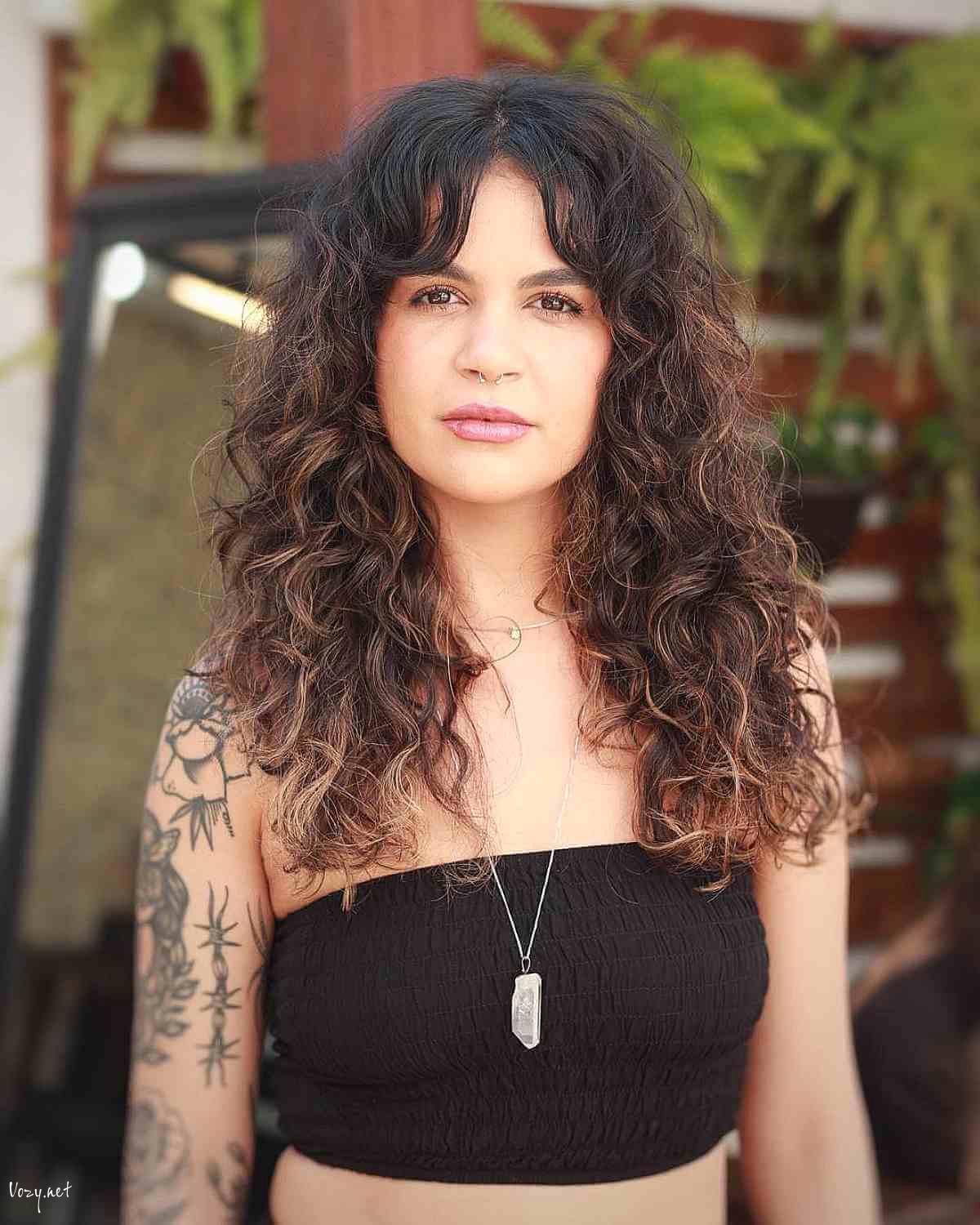 curly shag cut with blonde highlights