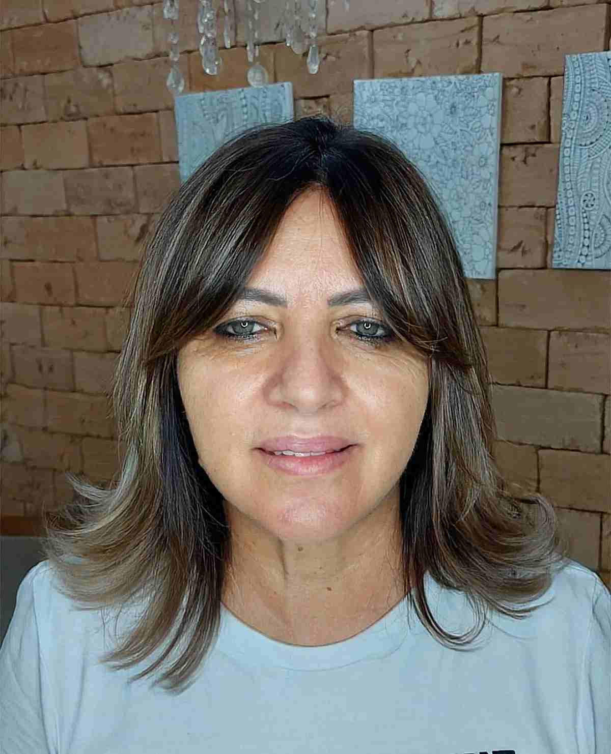 curtain bangs and a sleek shoulder length cut for fine hair for 60 year olds