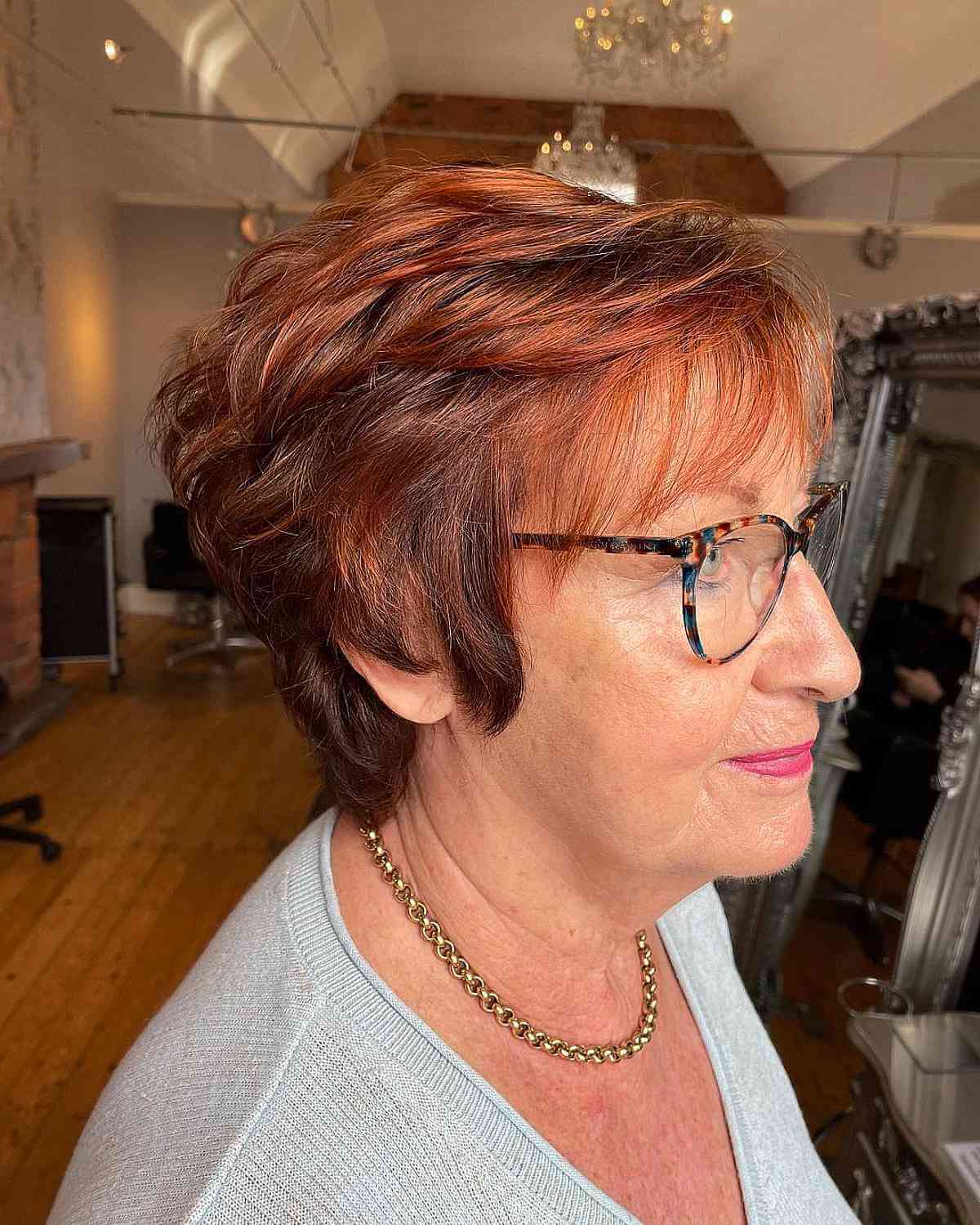dark auburn feathered bob for 60 year olds with glasses