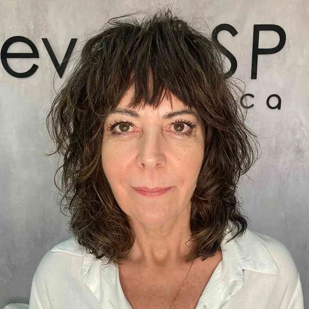 dark brown shag with choppy bangs for ladies 60 and up