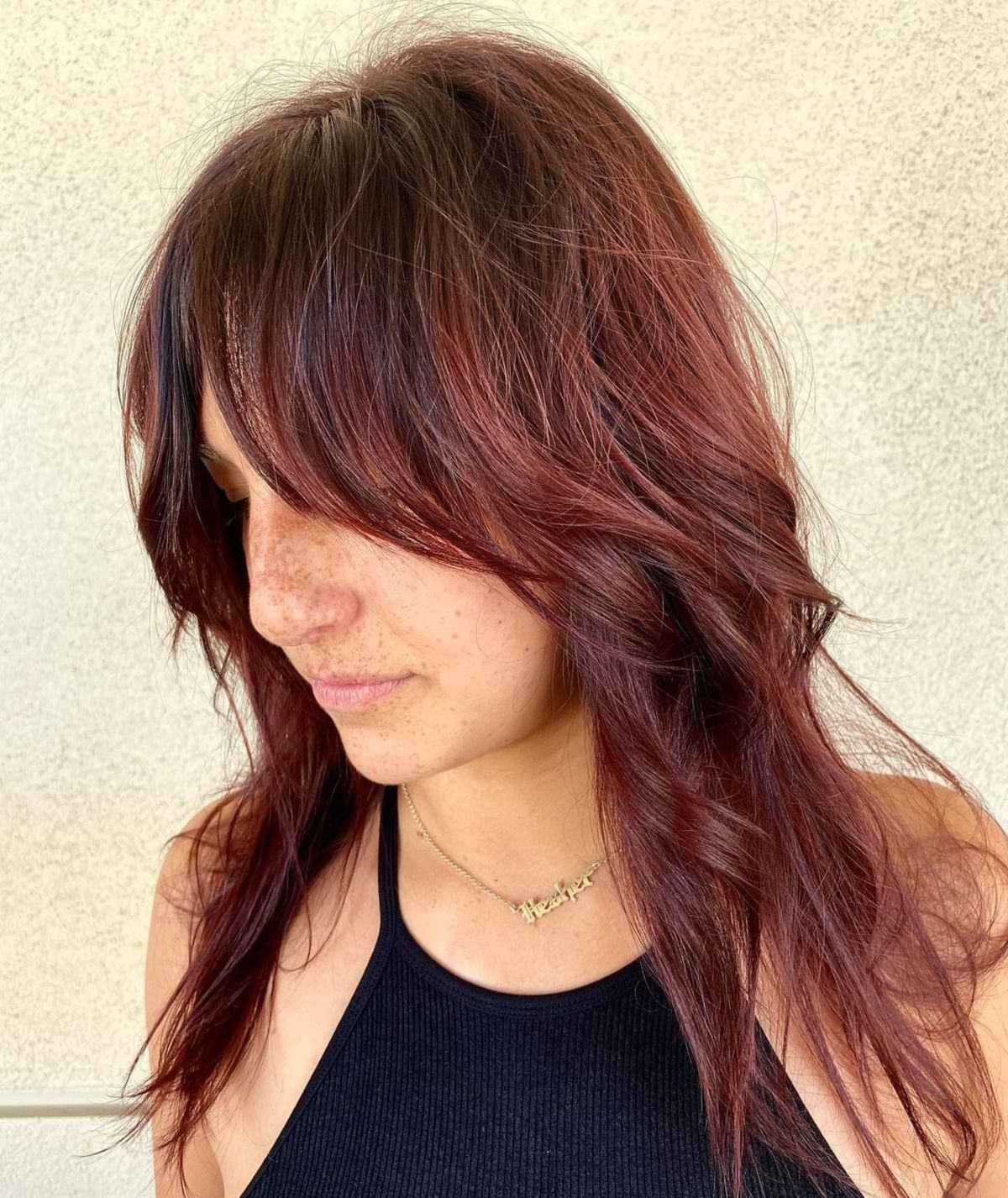 dark cherry long shag hairstyle with bangs