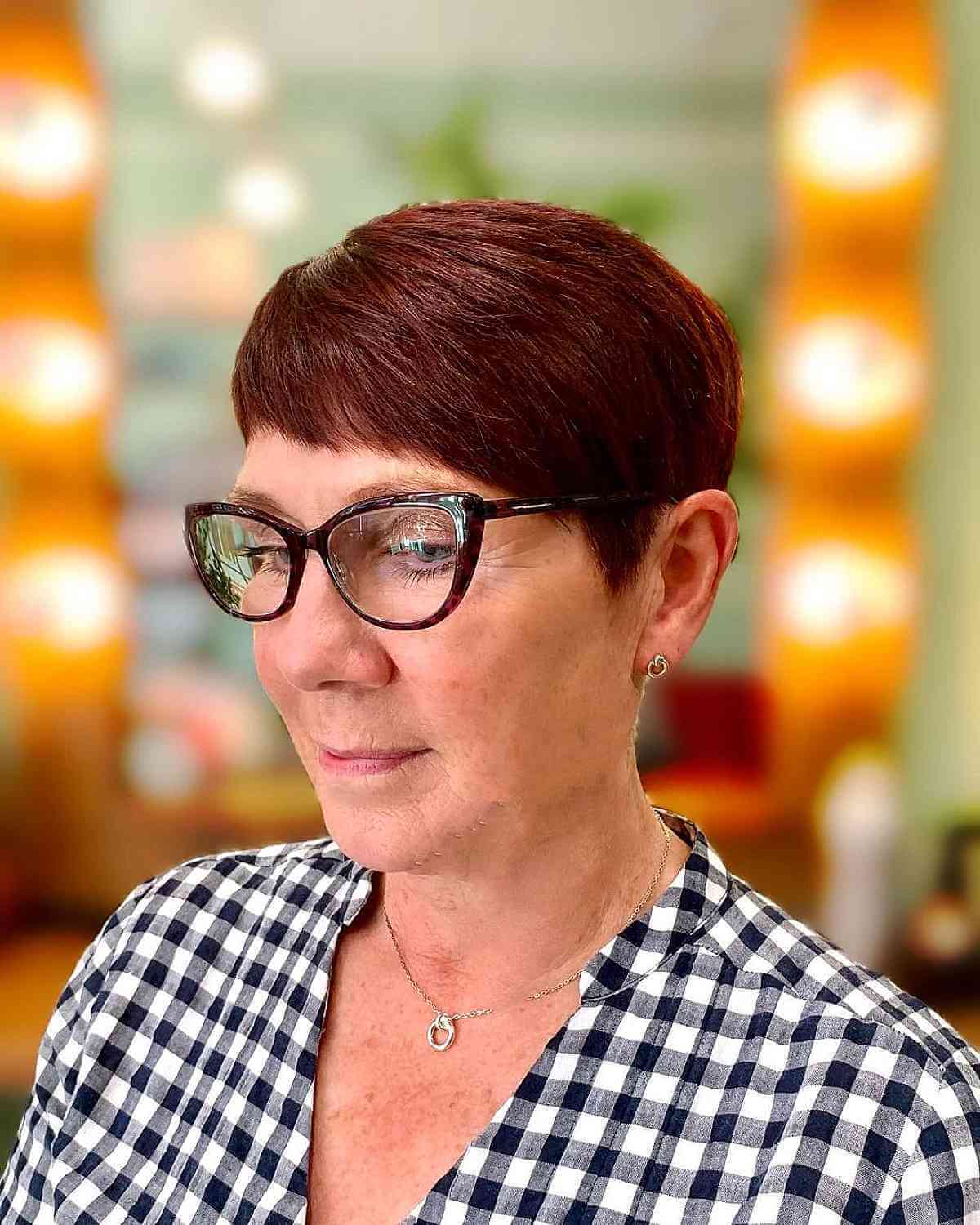 dark red pixie with side swept baby fringe for ladies 60 and up with glasses