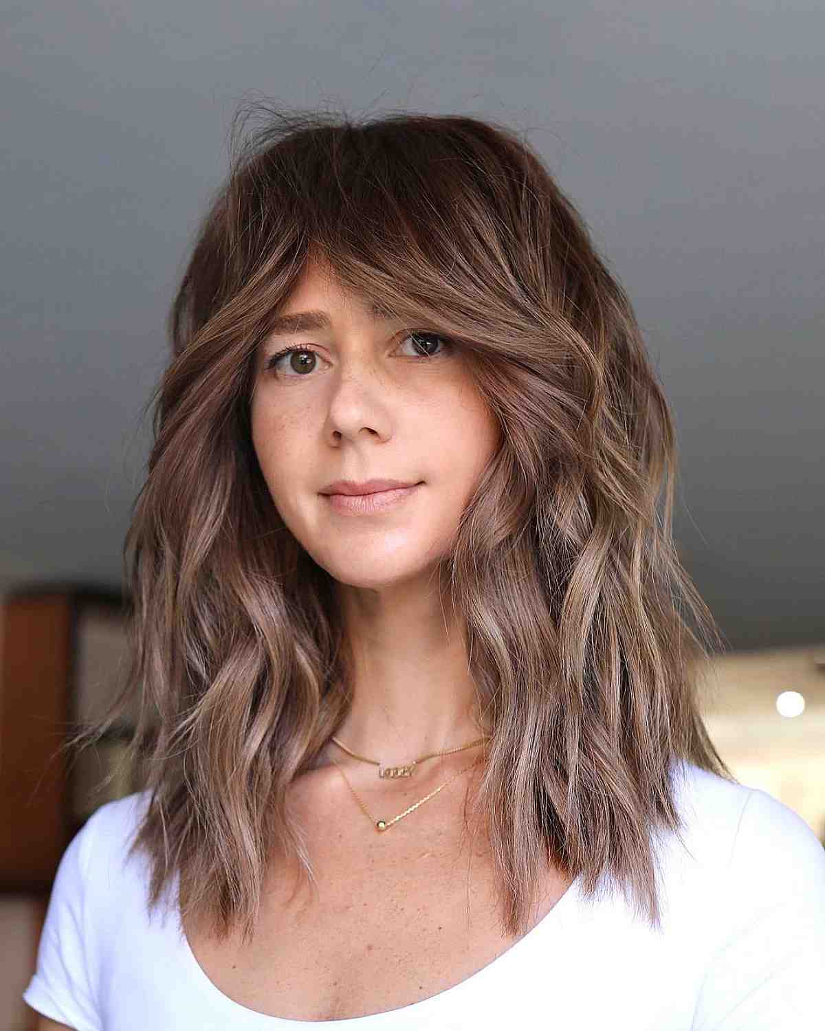 dimensional highlights with long curtain bangs