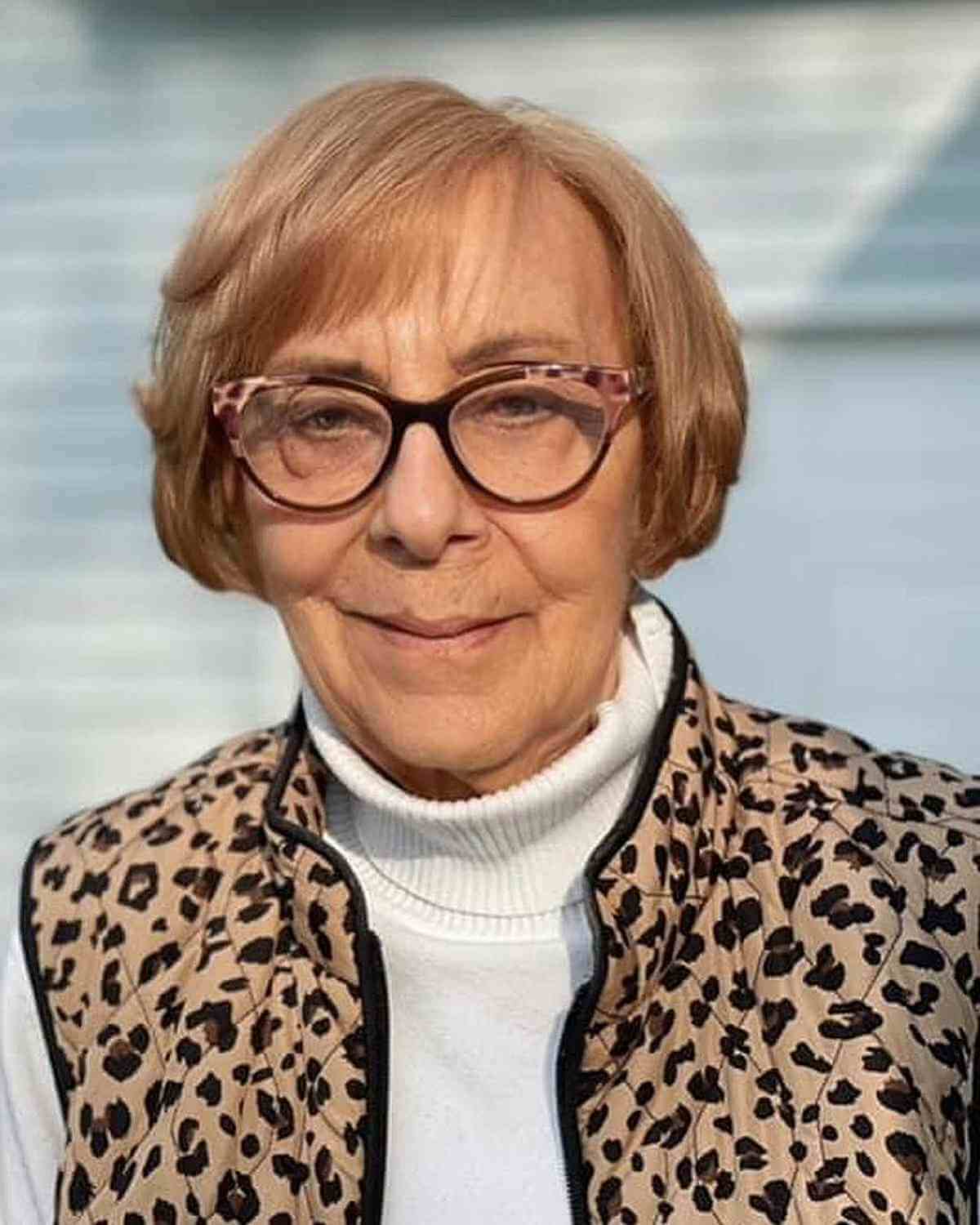 ear length soft bob with side swept bangs for 60 year olds with glasses