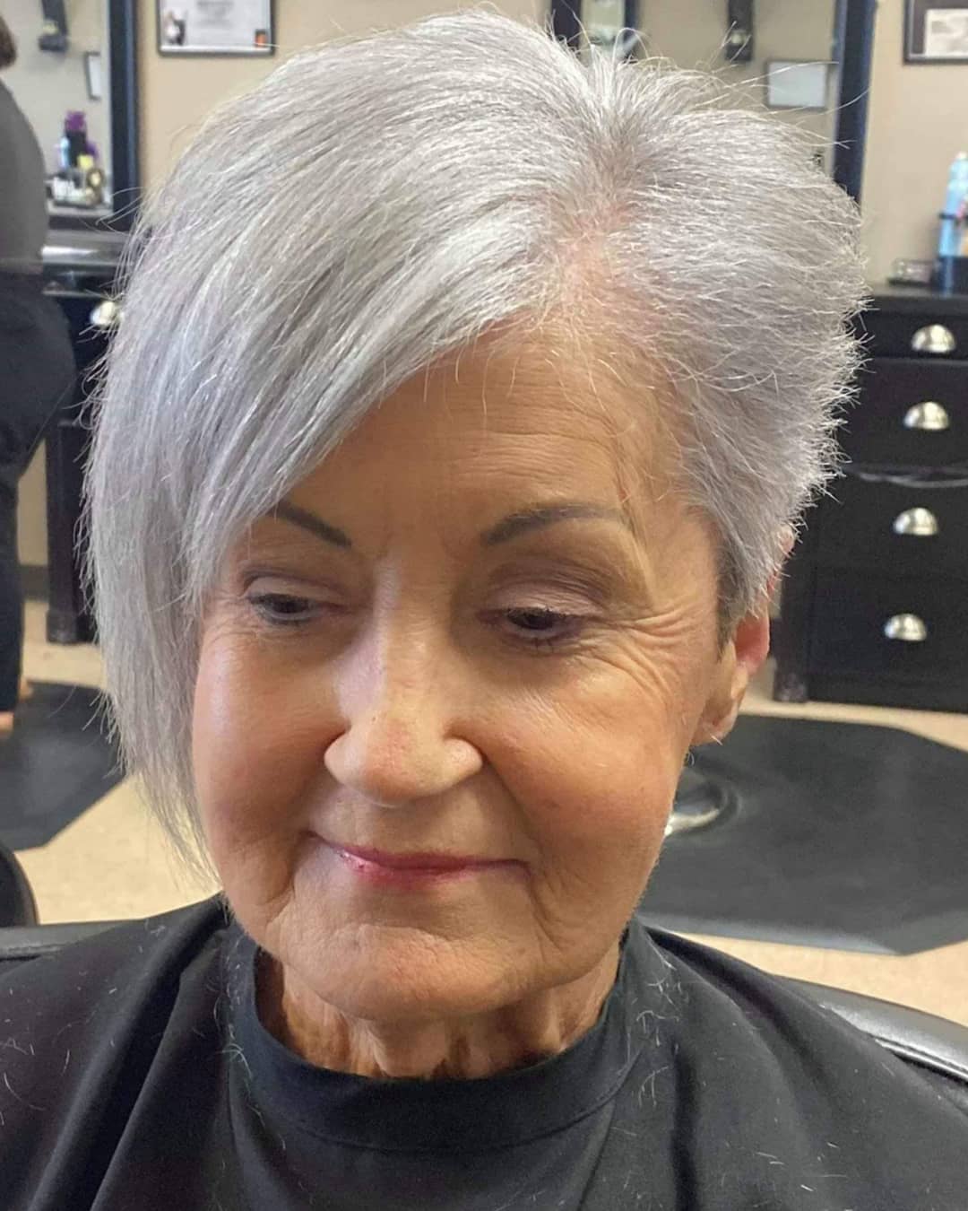 edgy gray pixie cut with long bangs for over 70