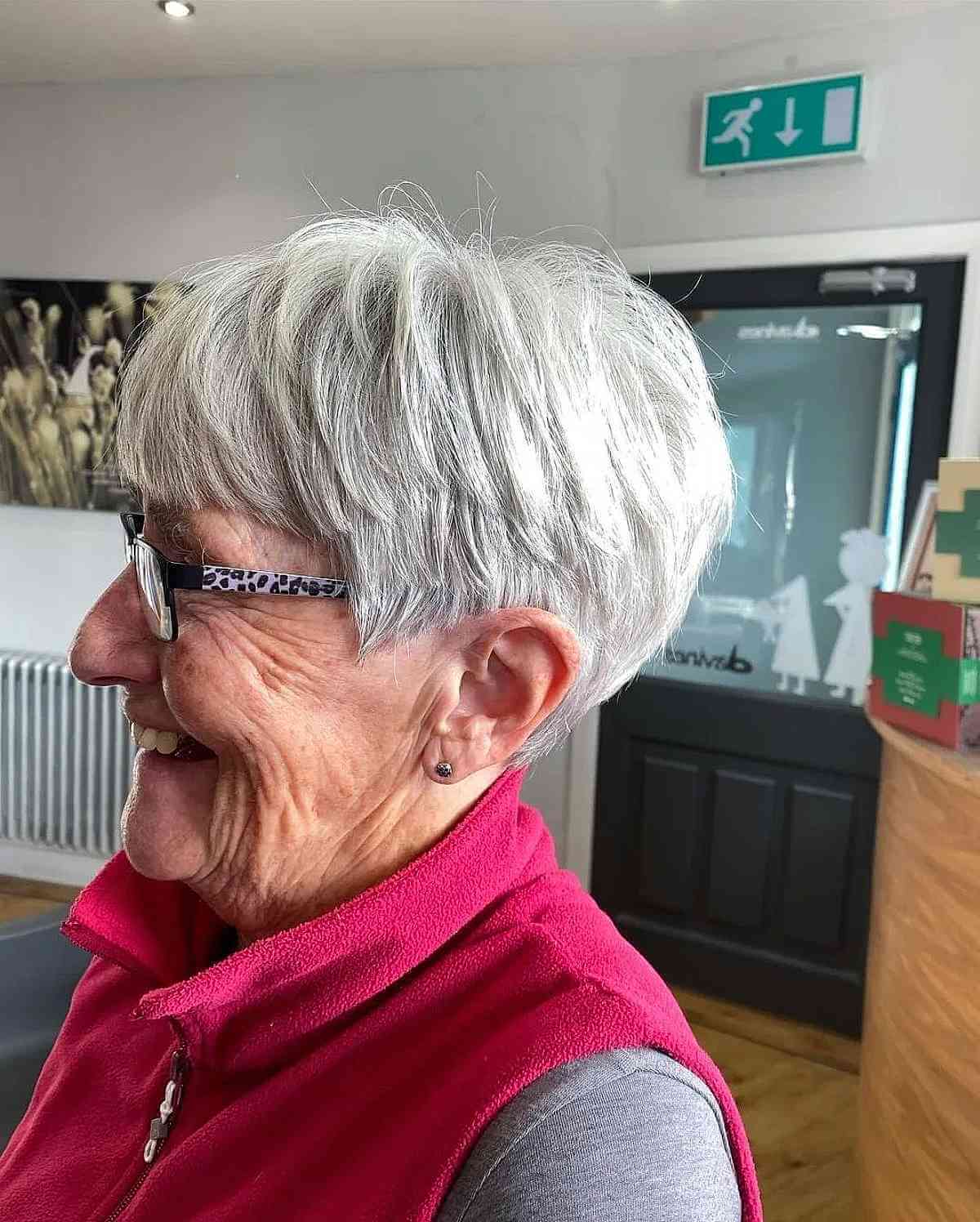 edgy pixie for women over 70 with silver hair and glasses