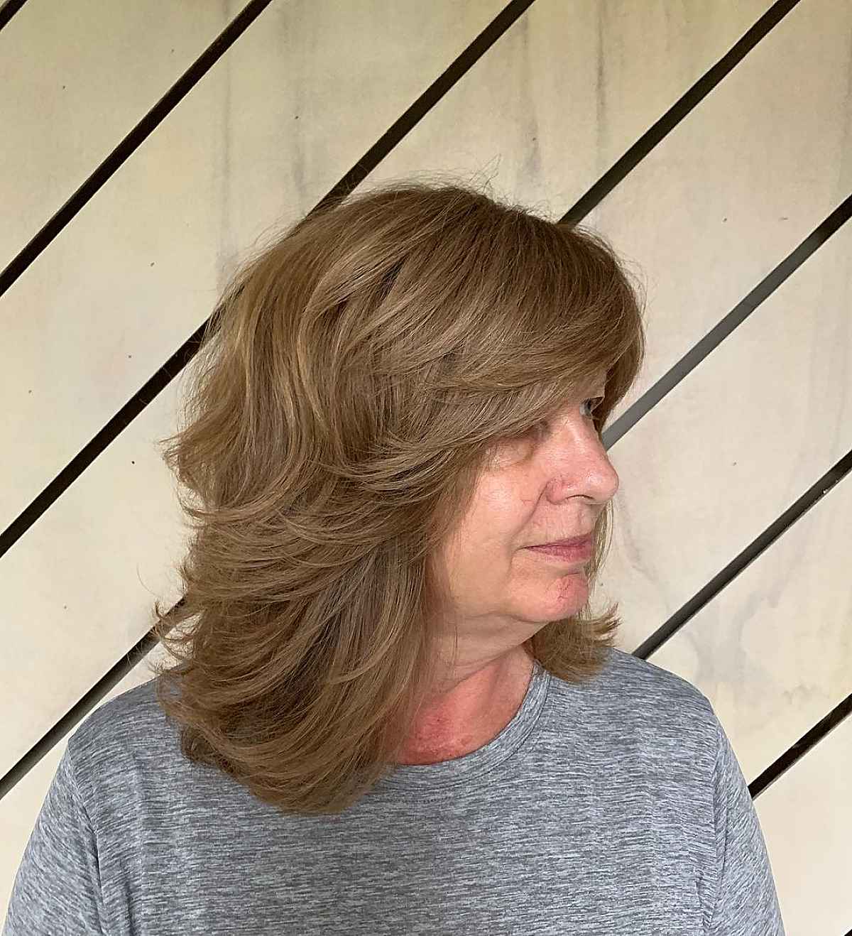 face framing layers and side swept bangs on a shag for 60 year old women