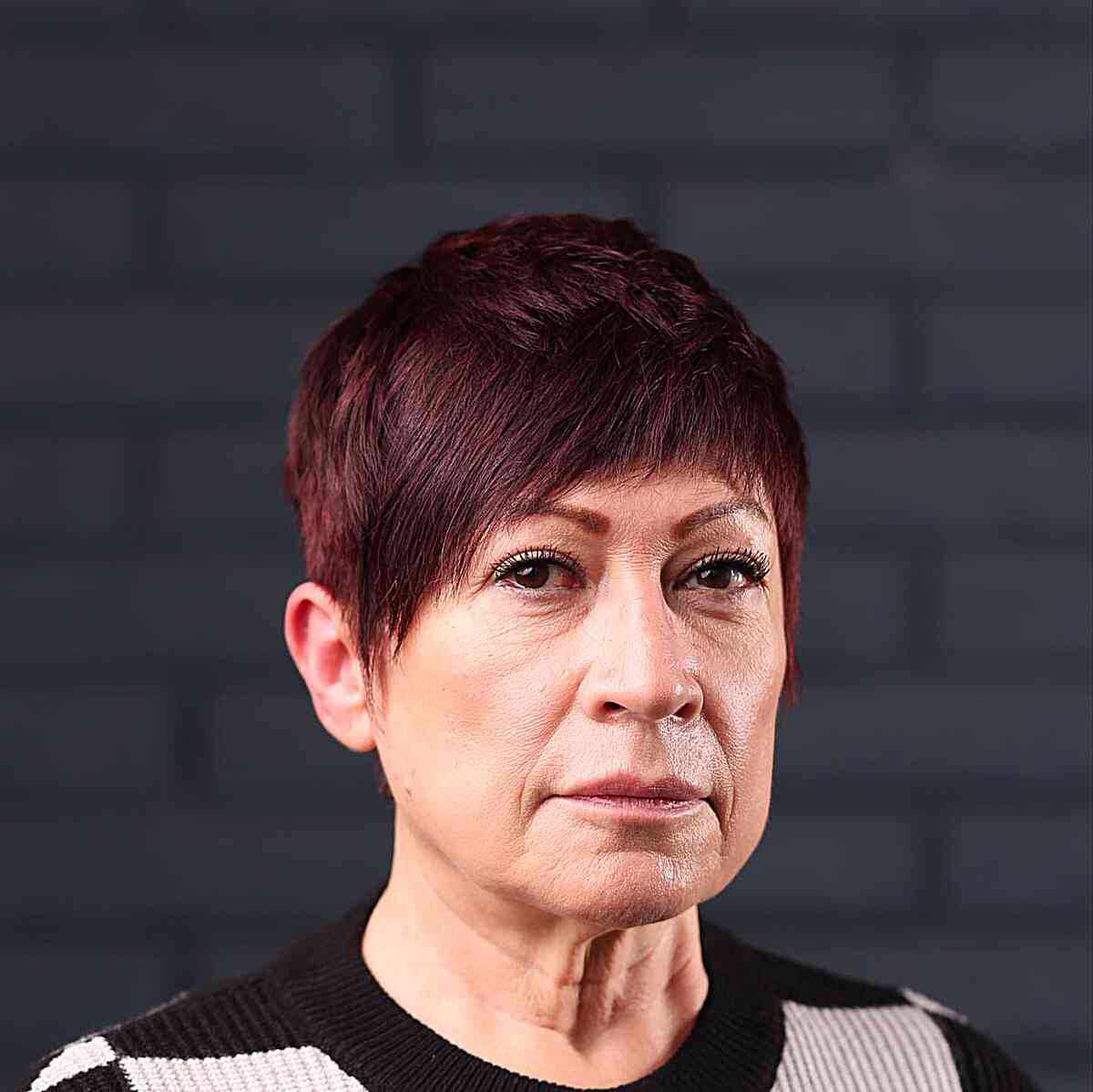 face framing pixie hair with rounded bangs and layers for 50 year olds