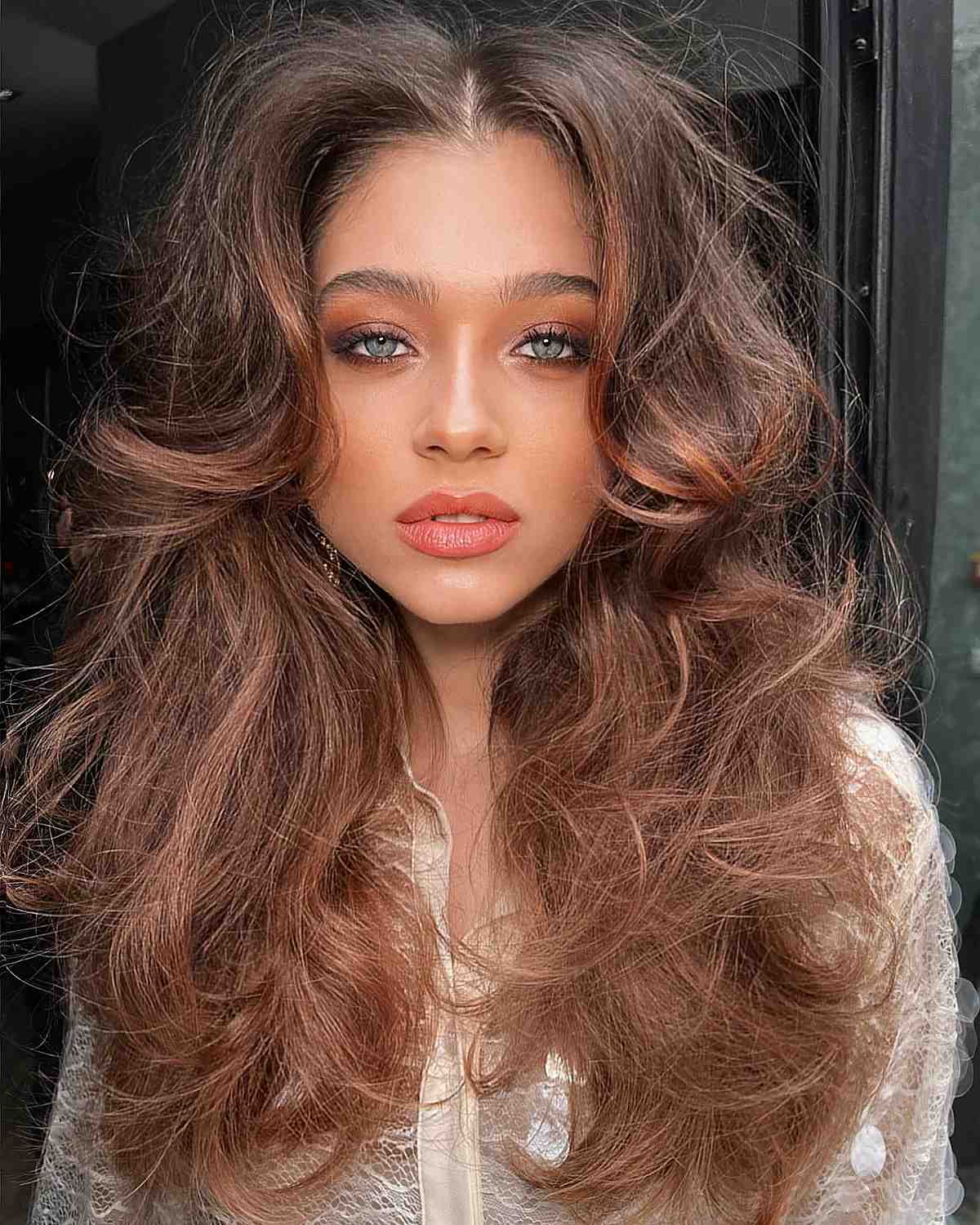 fluffy hair with a middle part